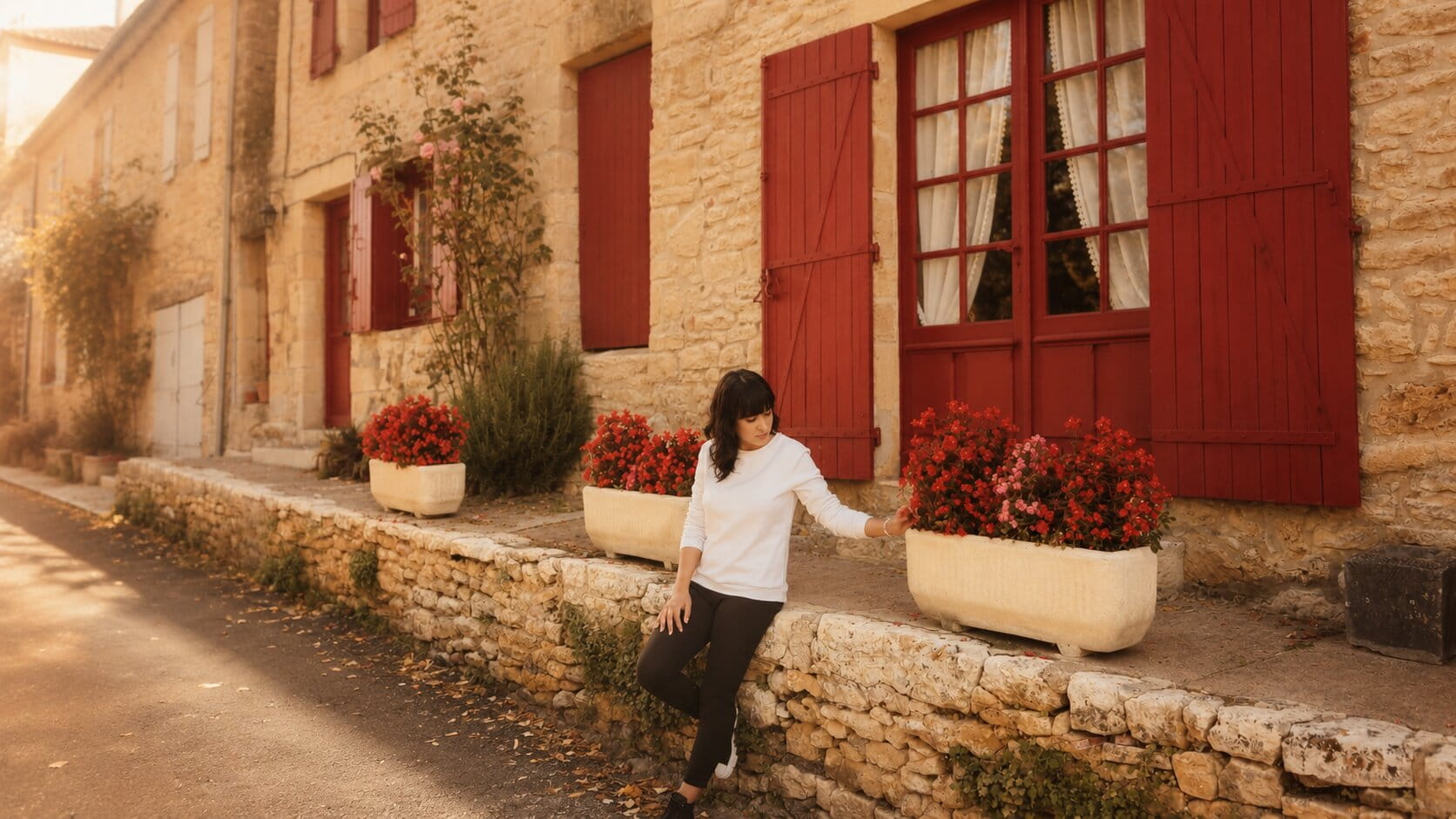 Roza in front of a warm French house
